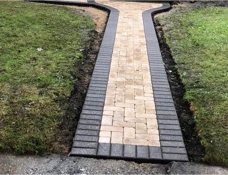 Brick paver walkway leading through a front yard in the Chicago area, R & G Almanza hardscaping installation