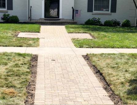 Curved brick paver walkway running through a Chicago-area yard, a hardscape idea from R & G Almanza Landscape