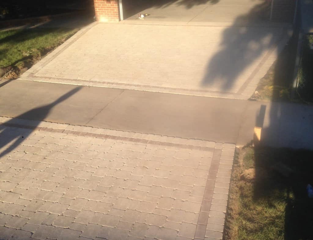 Brick paver driveway with a concrete apron leading to a suburban Chicago-area home