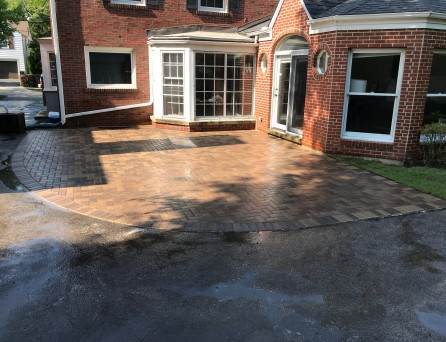 Finished brick paver patio beside a red-brick North Shore home, R&G Almanza patio installation