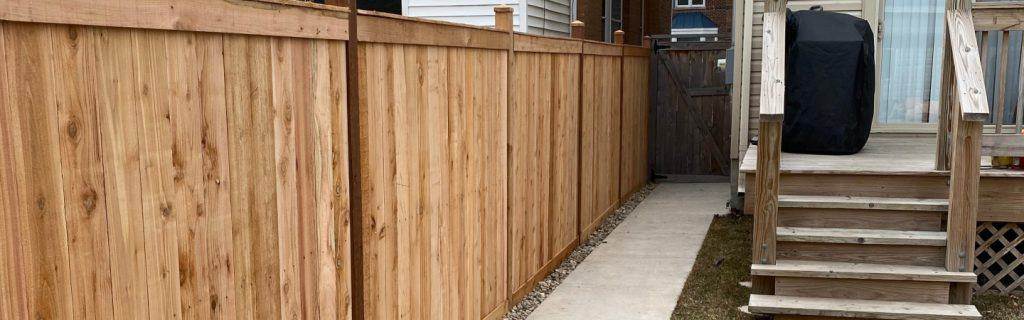 Cedar privacy fence installed by R & G Almanza along a residential back yard in the Chicago area