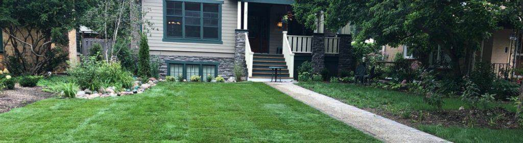 Front yard landscaping with new planting beds and a walkway on a Chicago-area residential property