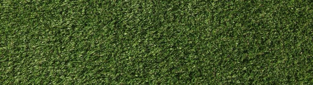 Close-up of synthetic turf blades and infill on an R & G Almanza Landscape Chicago turf installation