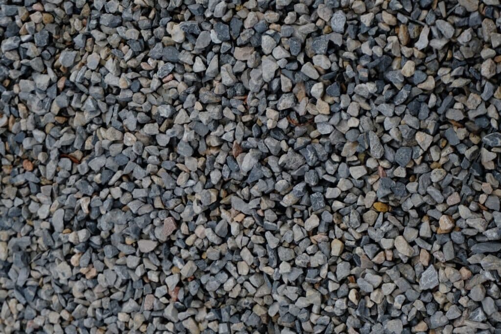 Crushed stone base compacted for a Chicago-area artificial turf installation by R & G Almanza Landscape