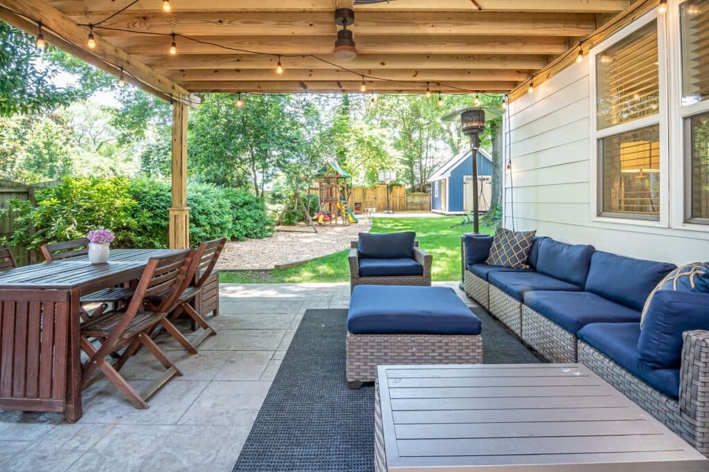 Covered patio pavilion with a wood dining table, the kind of shade an outdoor kitchen sits under