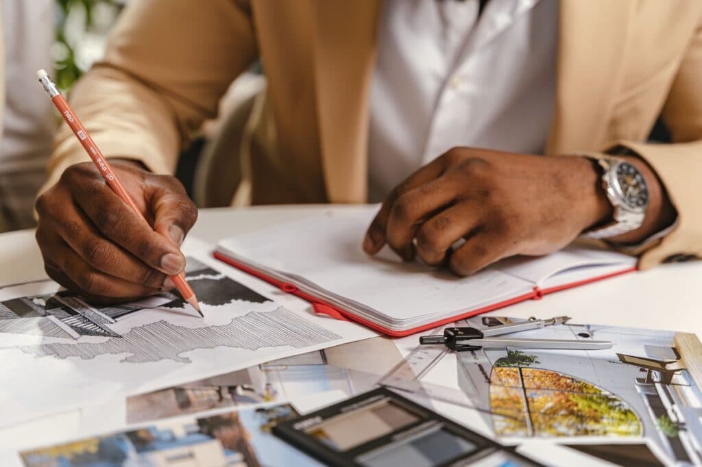 Designer sketching a landscape concept plan by hand, the drafting stage behind a Chicago design fee