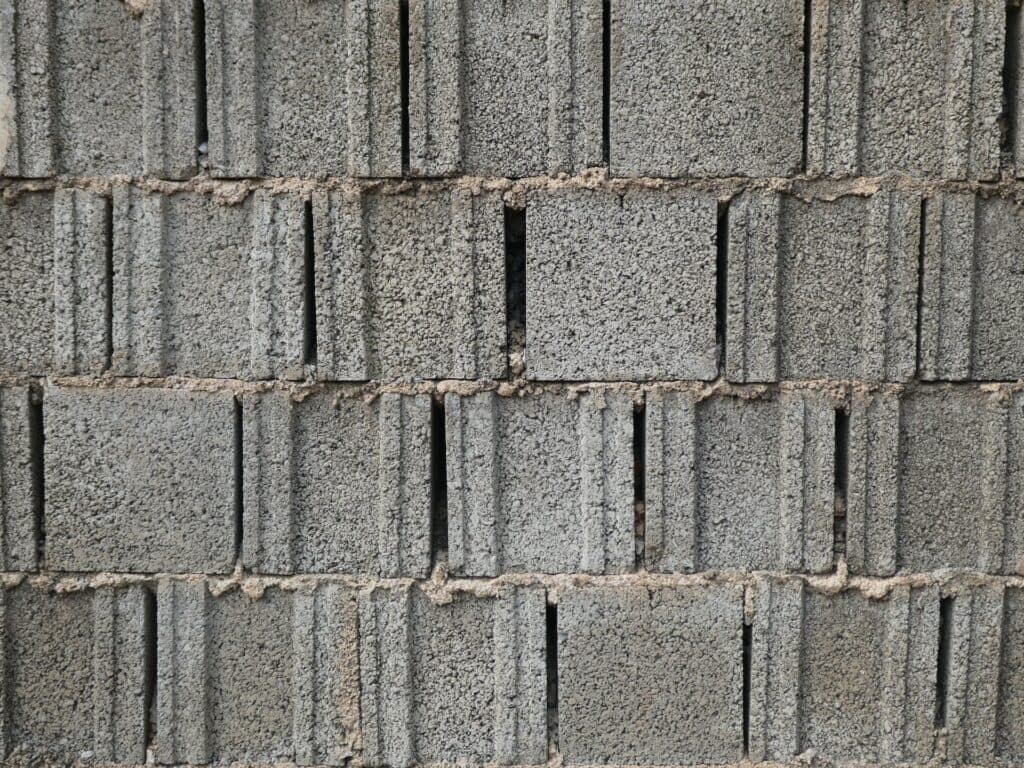 Gray concrete block wall coursing and mortar joints, the retaining wall material R & G Almanza rebuilds in Chicago yards