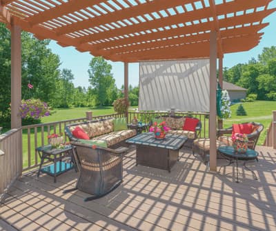 Freestanding pergola and deck structure over an outdoor living space