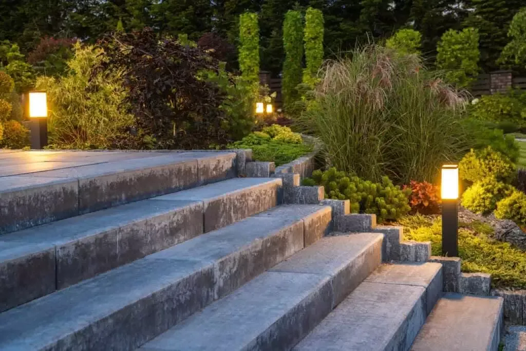 landscaped garden with concrete stairs and decorative illuminati